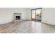 Living room with fireplace, tile floor and sliding door to patio and pool at 4842 E Surrey Ave, Scottsdale, AZ 85254