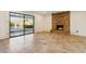 Living room with fireplace and sliding glass doors to pool at 4842 E Surrey Ave, Scottsdale, AZ 85254