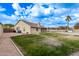 Landscaped backyard featuring a grassy area and pool at 4963 E Hobart St, Mesa, AZ 85205