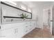 Double vanity bathroom with modern white cabinets at 4963 E Hobart St, Mesa, AZ 85205