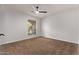 Bright bedroom with ceiling fan and carpet at 4963 E Hobart St, Mesa, AZ 85205