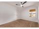 Bedroom with ceiling fan and carpet, view of backyard at 4963 E Hobart St, Mesa, AZ 85205