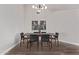 Modern dining room with wood table and black chairs at 4963 E Hobart St, Mesa, AZ 85205