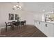 Modern dining room with a wood table and black chairs at 4963 E Hobart St, Mesa, AZ 85205