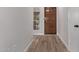 Light and airy entryway with wood flooring and a wooden door at 4963 E Hobart St, Mesa, AZ 85205