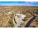 Aerial view of a home with a large driveway and desert landscape at 51008 N 295Th Ave, Wickenburg, AZ 85390