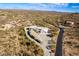 Aerial view of a home with a large driveway and desert landscape at 51008 N 295Th Ave, Wickenburg, AZ 85390