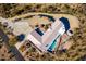 Aerial view of a home with pool, expansive driveway and desert landscape at 51008 N 295Th Ave, Wickenburg, AZ 85390