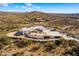 Aerial view of a home with a curved driveway and desert landscape at 51008 N 295Th Ave, Wickenburg, AZ 85390