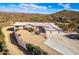 Aerial view of a home with a three-car garage and desert landscape at 51008 N 295Th Ave, Wickenburg, AZ 85390