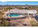 Aerial view showcasing a house with a pool and desert landscape at 51008 N 295Th Ave, Wickenburg, AZ 85390