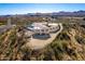 Aerial view of house on hillside with mountain views at 51008 N 295Th Ave, Wickenburg, AZ 85390