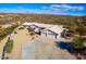 Aerial view of a home with a two-car garage and desert landscape at 51008 N 295Th Ave, Wickenburg, AZ 85390