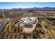 Aerial view of a home with a pool and desert landscape, nestled on a hillside at 51008 N 295Th Ave, Wickenburg, AZ 85390