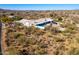 Aerial view of a home with pool, nestled in a desert landscape with mountain views at 51008 N 295Th Ave, Wickenburg, AZ 85390