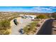 Aerial view of a house with a large driveway and mountain views at 51008 N 295Th Ave, Wickenburg, AZ 85390