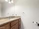 Bathroom with wood vanity, granite countertop, and sink at 51008 N 295Th Ave, Wickenburg, AZ 85390