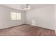 Well-lit bedroom with ceiling fan and window at 51008 N 295Th Ave, Wickenburg, AZ 85390