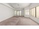 Bedroom with carpeted floor, sliding door, and large windows at 51008 N 295Th Ave, Wickenburg, AZ 85390