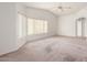 Bedroom with carpeted floor, large windows, and ceiling fan at 51008 N 295Th Ave, Wickenburg, AZ 85390