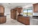 Kitchen features dark wood cabinets, granite countertops, and a window at 51008 N 295Th Ave, Wickenburg, AZ 85390