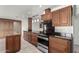 View of kitchen with island, dark wood cabinets, and granite counters at 51008 N 295Th Ave, Wickenburg, AZ 85390