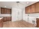 Spacious laundry room with wood cabinets and a toilet at 51008 N 295Th Ave, Wickenburg, AZ 85390