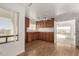 Laundry room with wood cabinets, access to patio, and view at 51008 N 295Th Ave, Wickenburg, AZ 85390