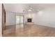 Living room with fireplace, sliding door to pool view, and hardwood floors at 51008 N 295Th Ave, Wickenburg, AZ 85390