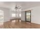 Living room with laminate wood floor and sliding glass doors at 51008 N 295Th Ave, Wickenburg, AZ 85390