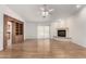 Living room boasts hardwood floors, fireplace, and built-in shelving at 51008 N 295Th Ave, Wickenburg, AZ 85390