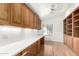 Home office with built-in wooden cabinets and shelving at 51008 N 295Th Ave, Wickenburg, AZ 85390