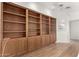 Large built-in wooden shelving unit in a bright room at 51008 N 295Th Ave, Wickenburg, AZ 85390