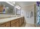 Bathroom with granite countertops, double sinks, and a walk-in shower at 5133 W Monte Cristo Ave, Glendale, AZ 85306