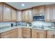 Granite countertop kitchen with modern cabinetry and microwave at 5133 W Monte Cristo Ave, Glendale, AZ 85306