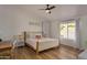 Bedroom with a wooden bed frame and access to the pool at 6102 W Whispering Wind Dr, Glendale, AZ 85310