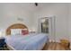 Guest bedroom with a wicker headboard and blue bedding at 6102 W Whispering Wind Dr, Glendale, AZ 85310