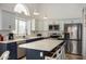 Modern kitchen with blue cabinets, stainless steel appliances, and an island at 6102 W Whispering Wind Dr, Glendale, AZ 85310