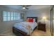 Cozy bedroom with a queen-size bed and wood furniture at 6151 E Harvard St, Scottsdale, AZ 85257