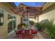 Outdoor patio with seating area, umbrella, and lush landscaping at 6151 E Harvard St, Scottsdale, AZ 85257