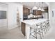 Modern kitchen with island, white countertops, and dark cabinets at 6741 W Desert Dr, Laveen, AZ 85339