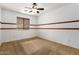 Bright bedroom with ceiling fan and neutral carpeting at 6845 S 7Th Ln, Phoenix, AZ 85041