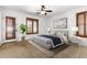 Main bedroom with plush carpet, large windows, and ceiling fan at 6845 S 7Th Ln, Phoenix, AZ 85041