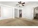 Spacious bedroom with carpet flooring and access to hallway bathroom at 6845 S 7Th Ln, Phoenix, AZ 85041