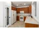 Kitchen with wooden cabinets, tiled floor, and stainless steel appliances at 6845 S 7Th Ln, Phoenix, AZ 85041