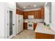 Kitchen with wooden cabinets, tiled floor, and stainless steel appliances at 6845 S 7Th Ln, Phoenix, AZ 85041