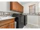 Laundry room with washer, dryer, and built-in cabinets at 6845 S 7Th Ln, Phoenix, AZ 85041