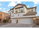 Two-story house with three car garage and stone accents at 687 E Cleveland Ct, San Tan Valley, AZ 85140