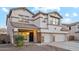 Two story house with three car garage and stone accents at 687 E Cleveland Ct, San Tan Valley, AZ 85140