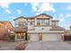 Two-story house with three car garage and stone accents at 687 E Cleveland Ct, San Tan Valley, AZ 85140